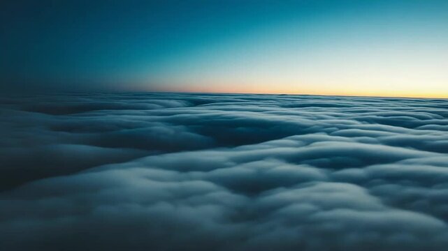 Vast cloudscape stretches to the horizon under a gradient sky at sunrise, creating a serene and boundless aerial view offering a feeling of freedom and peace