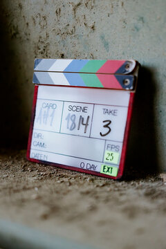 Film scene clapperboard on dusty surface
