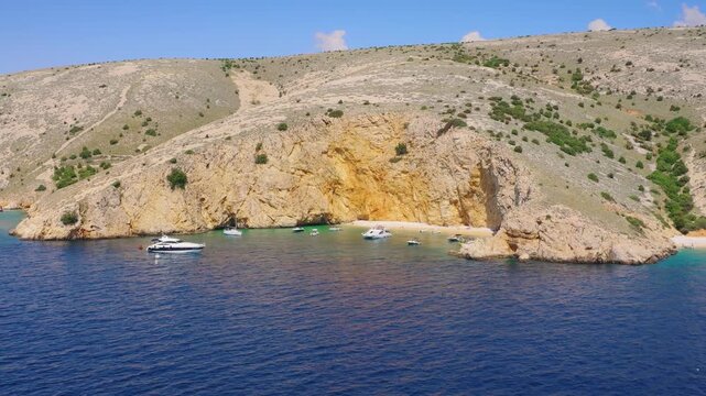 Sandy beach under cliffs at Zlata Beach