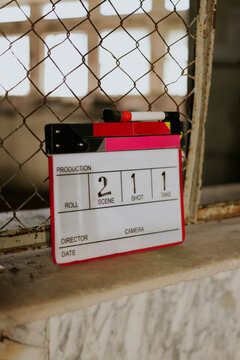 Clapperboard leaning on a window ledge in a film setting