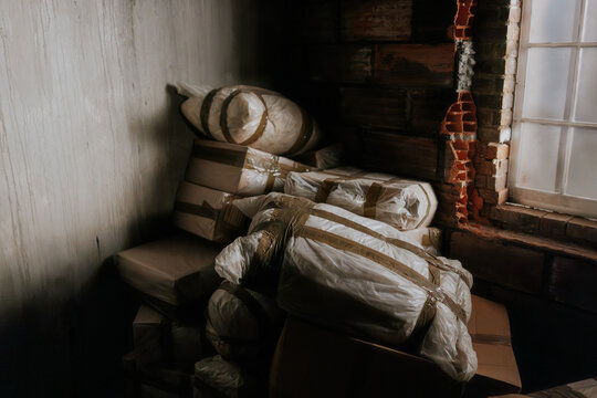 Stacked packages in dimly lit warehouse corner