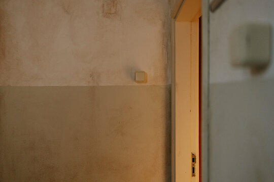 Rustic interior wall with open door and light switch