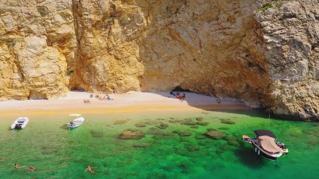 Zlata Beach sandy cove with people aerial view