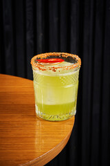 Refreshing orange citrus cocktail in a crystal rocks glass on a dark background
