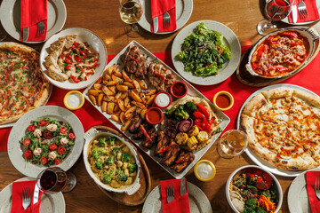 A lot of different food on the Banquet table.A large number of prepared dishes on the table.Holiday at the table