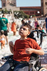 Child with cerebral palsy enjoying outdoor foam party