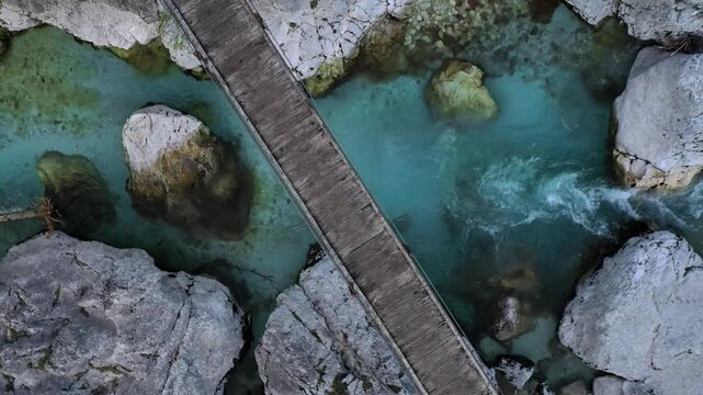 Turquoise river and wooden bridge aerial view