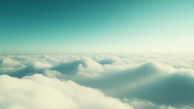 White fluffy cumulus clouds extend to the horizon, creating a serene and vast aerial landscape under a clear turquoise to light blue sky, suggesting freedom and tranquility