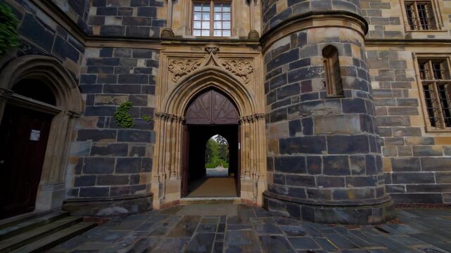 Imposing Stone Structure Featuring Elaborate Battlements And Decorative Turrets, Magnificent Historic Location Showcasing Grand Entrance And Lush Ivycovered Walls