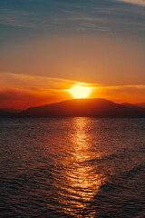 Fototapeta premium Fiery red sunset over Issyk-lul lake in Kyrgyzstan