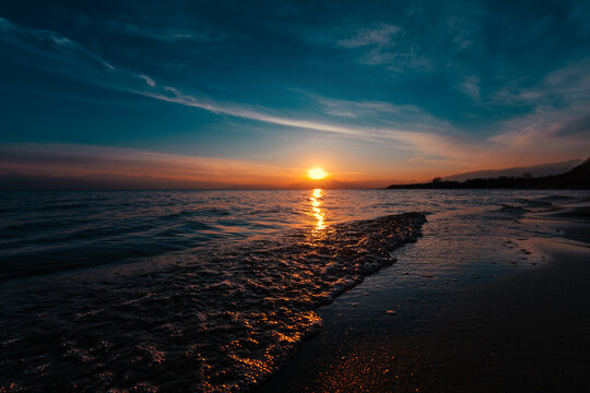 Red sunset over Issyk-lul lake in Kyrgyzstan in summer