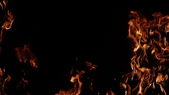 Burning flames igniting on a dark background