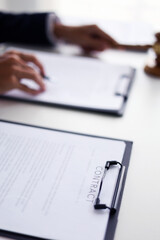 Legal counsel reading contract paperwork to finalize a legal agreement. Concepts for legal counsel, judicial authority, and the finality of a decision or agreement.&nbsp;