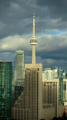 Obraz premium CN Tower Rising Above Toronto Skyline Under Dramatic Sky