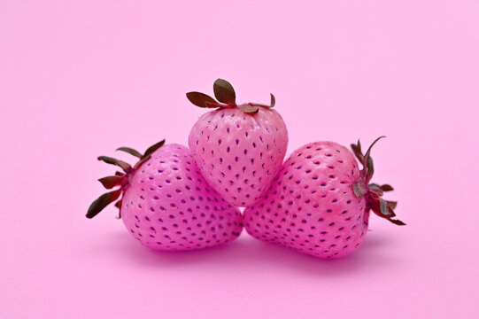bright colorful image of pink strawberries on a pink background