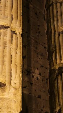 night towering fluted stone columns cracked surfaces deep grooves monumental verticality emerges piazza di pietra / temple hadrian reveals up close rome italy roman empire emperor 