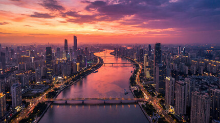 Vibrant sunset over a modern city skyline with a winding river and illuminated bridges.
