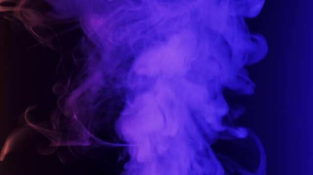 Thick plume of smoke rises and swirls against a solid black background. The smoke is illuminated by shifting neon lights, changing from blue and purple to green.
