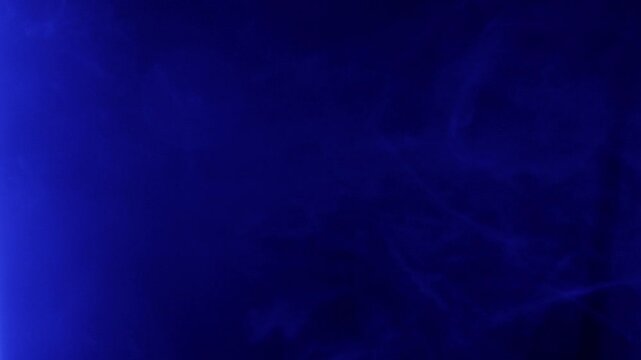 Wisps of smoke are illuminated by flashing red and blue lights against a black background. The dynamic effect creates a powerful and urgent atmospheric visual reminiscent of police sirens.