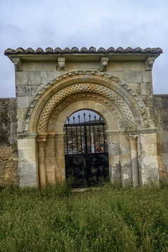 Romanesque cemetery gate with archivolts in Vega de Bur