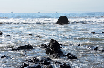 Tar Pit Rock Formations in the Ocean with Waves