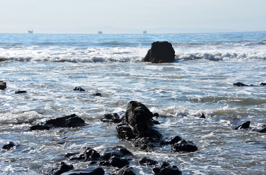 Tar Pit Rock Formations in the Ocean with Waves
