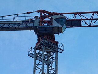 bright daytime industrial scene, sunlit tower showcases detailed steel framework and platform stairs © Nataliia