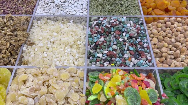 A colorful dry‑food display in Dubai&rsquo;s Deira Old Souk, showcasing spices, nuts, and grains in vibrant arrangements.