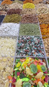 A colorful dry‑food display in Dubai&rsquo;s Deira Old Souk, showcasing spices, nuts, and grains in vibrant arrangements.