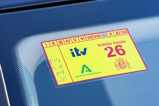 Seville, Spain; December 31, 2025: Close-up of spanish ITV vehicle inspection sticker for 2026 on car windshield.