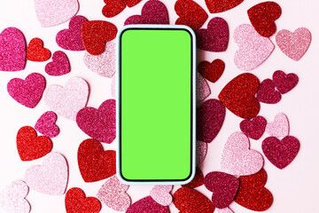 Valentine's day phone mockup. Empty phone screen flat lay with stylish pink and red glitter hearts on pink paper background. Happy Valentine's day smartphone template with space for text