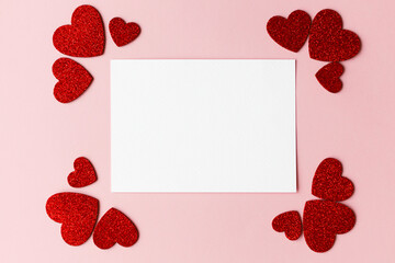 Happy Valentine's day greeting card! Empty card with space for text and stylish pink and red hearts flat lay on pink paper background. Modern love postcard mockup