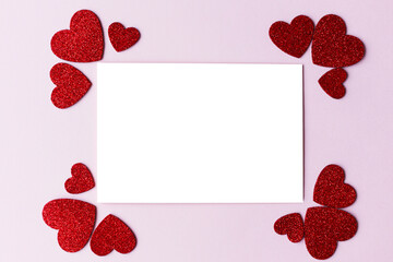 Valentines day card mockup. Empty greeting card flat lay with stylish pink and red glitter hearts on pink paper background. Happy Valentine's day postcard with space for text