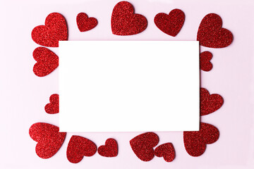 Happy Valentine's day greeting card! Empty card with space for text and stylish pink and red hearts flat lay on pink paper background. Modern love postcard mockup