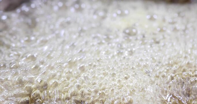 Melted sugar dissolved in water boiling, making syrup for oriental cakes like baklava