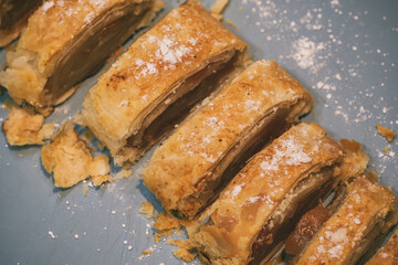 a cut puff pastry roll with filling lies on the table