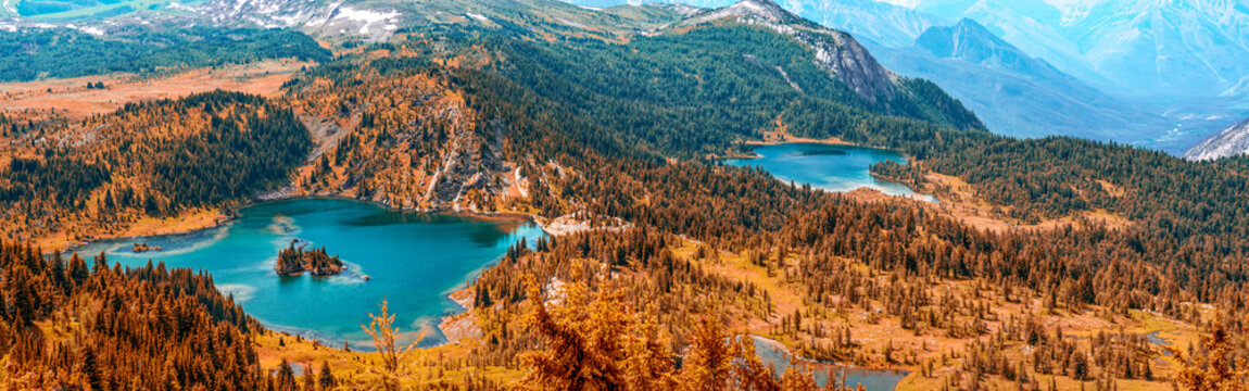 Vibrant autumn aerial perspective of pristine lakes nestled in Sunshine Meadows with fiery orange red meadows Rocky Mountains Alberta Canada wilderness