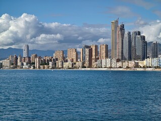 Fototapeta premium Modern urban skyline with reflective glass skyscrapers and energetic waterfront environment