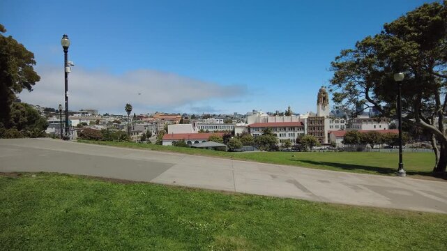 Calm urban park scene captured as a steady background clip suitable for city life, lifestyle, and everyday atmosphere concepts. Filmed in Mission Dolores Park, San Francisco