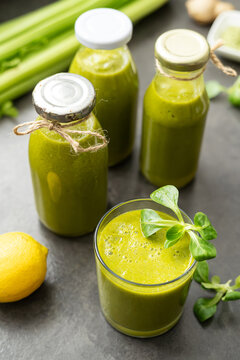 Green smoothie with vegetables, fruits and superfoods on dark background