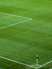 Soccer Field Corner Flag On Green Grass With White Boundary Lines © Giedrius
