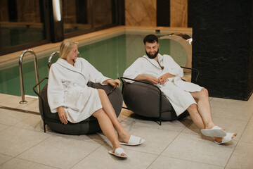 Couple relaxing by pool at luxury spa resort
