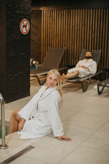 Couple relaxing at modern hotel spa complex
