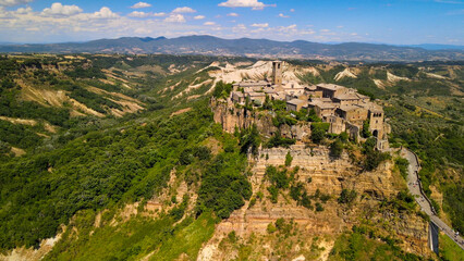 Obraz premium Panoramic aerial view of Civita di Bagnoregio from a flying drone around the medieval city, Italy.