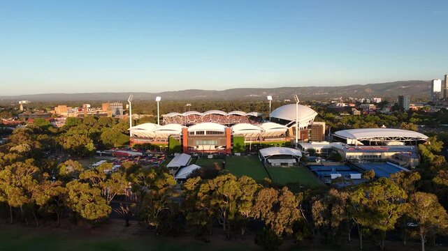 North Adelaide, South Australia: 4K Aerial Drone Footage of Adelaide Oval, Sport Stadium, City Skylines, CBD, Towers, River Torrens, Parklands, Urban Landscape at Sunset