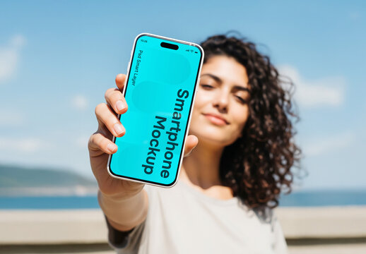 A woman stretching her arm to show a smartphone - mockup
