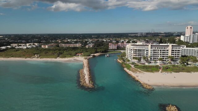 Aerial View of Boca Raton Inlet with Rock Jetties, Luxury Beachfront Resort, and Turquoise Coastal Water.