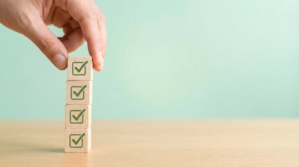 hand placing wooden blocks with green checkmarks on table