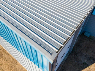 High Resolution Aerial Drone View of Gray Standing Seam Metal Roof On Commercial Building © Oak City Drone