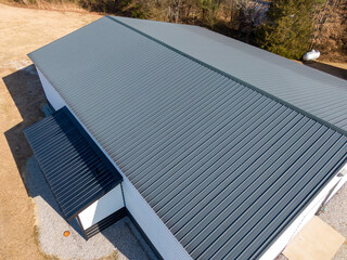 High Resolution Aerial Drone View of Gray Standing Seam Metal Roof On Commercial Building © Oak City Drone